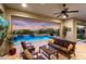 Outdoor living space with a refreshing pool, covered patio, and comfortable seating, perfect for entertaining at 5033 N 205Th Gln, Buckeye, AZ 85396
