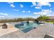 Beautiful backyard with a sparkling pool, spillover spa, and meticulously designed patio at 5033 N 205Th Gln, Buckeye, AZ 85396