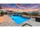 Captivating backyard displaying a pool, spa, outdoor kitchen, dining area, and lush landscaping at 5033 N 205Th Gln, Buckeye, AZ 85396