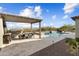 Backyard featuring a pool, spa, outdoor kitchen, and dining area under a pergola with stunning landscape at 5033 N 205Th Gln, Buckeye, AZ 85396