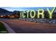 Illuminated 'VICTORY' sign stands as a beacon, greeting everyone at the entrance of the community at 5033 N 205Th Gln, Buckeye, AZ 85396