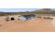 An aerial view showcases the home's gray exterior, expansive lot and mountain views at 51134 W Bluejay St, Maricopa, AZ 85139