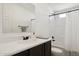 Well-lit bathroom featuring a sleek vanity with modern fixtures and a shower-tub combination with tiled walls at 51134 W Bluejay St, Maricopa, AZ 85139