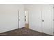 Spare bedroom with neutral carpeting and an open door looking out into another part of the house at 51134 W Bluejay St, Maricopa, AZ 85139