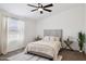 Cozy bedroom with soft carpet, neutral decor, and ample natural light from the window at 51134 W Bluejay St, Maricopa, AZ 85139