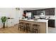 Modern kitchen island with seating and stainless steel appliances at 51134 W Bluejay St, Maricopa, AZ 85139