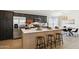 Modern kitchen boasts stainless steel appliances, sleek cabinets, and a central island with seating at 51134 W Bluejay St, Maricopa, AZ 85139