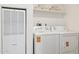 Functional laundry area showcasing a washer and dryer set, complemented by a storage shelf above at 51134 W Bluejay St, Maricopa, AZ 85139