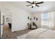 Relaxing main bedroom featuring a ceiling fan and accent chair, perfect for unwinding at 51134 W Bluejay St, Maricopa, AZ 85139