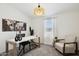 Bright home office with a large window, modern desk, and comfortable seating area at 51134 W Bluejay St, Maricopa, AZ 85139