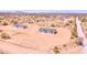 An aerial view shows a single story home with gray roof on a large desert lot at 51942 W Sotol Rd, Maricopa, AZ 85139