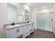 Bright bathroom featuring double sinks, modern fixtures, and sleek walk-in shower at 51942 W Sotol Rd, Maricopa, AZ 85139