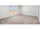 Bright and airy bedroom with neutral carpet, large window with natural light, and a minimalist design at 51942 W Sotol Rd, Maricopa, AZ 85139