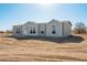 New single-story home boasts a symmetrical design and a freshly landscaped yard under a clear blue sky at 51942 W Sotol Rd, Maricopa, AZ 85139