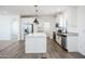 Modern kitchen boasts white cabinetry, stainless steel appliances, and stylish pendant lighting at 51942 W Sotol Rd, Maricopa, AZ 85139