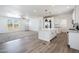 Spacious kitchen featuring white cabinets, island with pendant lighting, and modern stainless steel appliances at 51942 W Sotol Rd, Maricopa, AZ 85139