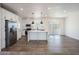 Bright living room features stainless steel appliances, center island, and sliding glass doors at 51942 W Sotol Rd, Maricopa, AZ 85139