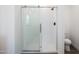 This glass enclosed shower has modern fixtures and a sleek design at 51942 W Sotol Rd, Maricopa, AZ 85139