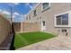 Backyard with pavers, a small patch of synthetic grass and access to the back of the home at 5232 N 16Th Ln, Phoenix, AZ 85015