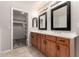 Bathroom featuring a double sink vanity and an open walk-in closet space at 5232 N 16Th Ln, Phoenix, AZ 85015