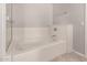 Bright bathroom features a soaking tub with a tile surround and glass door at 5232 N 16Th Ln, Phoenix, AZ 85015