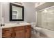 Bathroom featuring a wooden vanity, a mirror, and a shower with a glass door at 5232 N 16Th Ln, Phoenix, AZ 85015