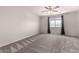The bedroom features carpet floors, a ceiling fan and a large window at 5232 N 16Th Ln, Phoenix, AZ 85015