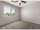 Bedroom featuring neutral carpet, a window with blinds, and two electrical outlets at 5232 N 16Th Ln, Phoenix, AZ 85015