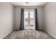 Bedroom featuring neutral carpet, blue curtains, and a glass paneled door at 5232 N 16Th Ln, Phoenix, AZ 85015