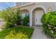 Close-up of the front door with a charming arched entryway and mature landscaping at 5232 N 16Th Ln, Phoenix, AZ 85015