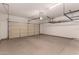 Spacious two car garage featuring sealed concrete floors and overhead storage racks at 5232 N 16Th Ln, Phoenix, AZ 85015