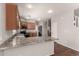 This kitchen features granite countertops, stainless steel appliances and light wood cabinetry at 5232 N 16Th Ln, Phoenix, AZ 85015