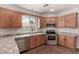 The kitchen features stainless steel appliances, granite countertops, tile backsplash and wood cabinetry at 5232 N 16Th Ln, Phoenix, AZ 85015