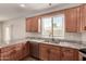 Well-lit kitchen featuring granite countertops, wood cabinetry, and stainless steel dishwasher at 5232 N 16Th Ln, Phoenix, AZ 85015