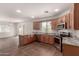 This kitchen features granite counters, stainless appliances, tile floors and light wood cabinets at 5232 N 16Th Ln, Phoenix, AZ 85015