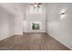 Spacious living room with vaulted ceilings, wood floors, and modern light fixtures at 5232 N 16Th Ln, Phoenix, AZ 85015