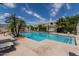 Outdoor pool surrounded by palm trees with plenty of deck chairs at 5232 N 16Th Ln, Phoenix, AZ 85015