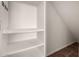 A shelved storage area with a tiled floor and bright white walls at 5232 N 16Th Ln, Phoenix, AZ 85015