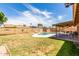 Spacious backyard with a private pool, covered patio, and secure block fence at 5320 W Maui Ln, Glendale, AZ 85306