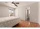 Bedroom with ceiling fan, a window, and a door leading to the bathroom at 5320 W Maui Ln, Glendale, AZ 85306