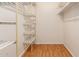 Walk-in closet with wire shelving and laminate flooring, offering ample storage space at 5320 W Maui Ln, Glendale, AZ 85306