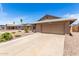 Front view showcasing a two-car garage and spacious driveway at 5320 W Maui Ln, Glendale, AZ 85306