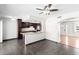 Open kitchen featuring an island with granite countertops and rich wood cabinets at 5320 W Maui Ln, Glendale, AZ 85306