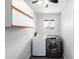 Bright laundry room features a washer, dryer, and overhead cabinets for ample storage at 5320 W Maui Ln, Glendale, AZ 85306