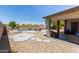 Backyard oasis features a sparkling pool, lush landscaping, and covered patio, perfect for outdoor living at 6002 N 124Th Dr, Litchfield Park, AZ 85340
