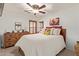 Inviting bedroom showcasing a ceiling fan, shuttered windows, and a comfy bed with decorative pillows at 6002 N 124Th Dr, Litchfield Park, AZ 85340