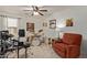 Versatile bonus room featuring drum set, ceiling fan, comfy chair, and neutral carpet at 6002 N 124Th Dr, Litchfield Park, AZ 85340