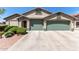 Charming home featuring a neutral color scheme, well-kept landscaping, and a spacious three-car garage at 6002 N 124Th Dr, Litchfield Park, AZ 85340