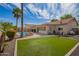 Expansive backyard featuring lush artificial grass, a pool, and mature landscaping at 605 S Monterey St, Gilbert, AZ 85233