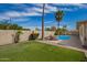 Serene backyard with artificial turf, a refreshing pool, and privacy landscaping at 605 S Monterey St, Gilbert, AZ 85233